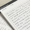 B5 grid notepad detail shot showing minimalist tearable paper and clear handwriting notes. - Checkered