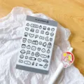 Close-up detail of cute black and white cartoon daily doodle sticker sheet for journal decor. - Gray