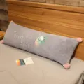 Cute long plush body pillow with pom poms and cute embroidery for bedroom bed use. - Kiwi