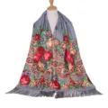 Detailed close-up view of a retro floral patterned grey scarf with stylish fringe tassels. - Gray