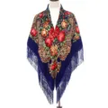 Close up of the exquisite Russian style floral print and delicate fringe on the blue shawl. - Sapphire Blue