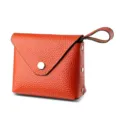 Orange leather mini coin purse with snap closure and loop handle, compact wallet design. - Orange