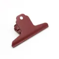 Detailed close-up shot of a large metal bulldog clip in dark red for office organization - 100mm / Brick Red