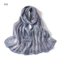 Detailed close-up view of elegant grey long scarf with blue embroidery and delicate sequins. - Pattern #2