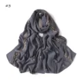 Close-up detail of the elegant grey scarf featuring pink embroidered roses and delicate bows. - Dark Gray