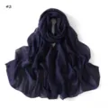 Close-up detail of navy blue long scarf featuring sparkling colorful sequin stripes. - Pattern #2