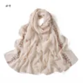 Delicate pink floral and ribbon embroidery detail on lightweight chiffon scarf fabric surface. - Off White