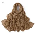Detailed view of a solid brown crinkle rayon scarf with rolled edges and breathable fine stripes. - Size 9
