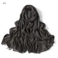 Detailed view of the dark grey crinkled textured fringe scarf showing fine pleated fabric. - Dark Gray