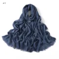 Detailed view of the dark blue crinkled slub cotton scarf showing soft frayed texture. - Dark Blue