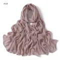Detail view of dusty pink crinkle rayon hijab scarf, featuring fine texture and rolled edges. - 14#