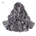Detail view of a grey satin imitation silk long scarf featuring subtle jacquard leopard pattern. - Gray