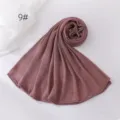 Detailed view of the solid color crinkle hijab scarf in dusty rose, lightweight polyester. - Dusty Pink