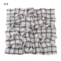 Detail shot of the black and white plaid chiffon square scarf featuring a chic swirl design. - Beige Polka Dot