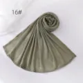 Green solid color wrinkled hijab scarf detail view, soft and breathable polyester fabric material. - Green