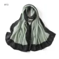 Close-up detail of the pleated long scarf with black dotted border and sage green center. - Style #10