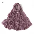 Close-up view of purple jersey scarf featuring delicate rhinestone flower details and soft texture. - Purple