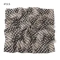 Close-up detail of black and white printed chiffon square scarf vintage plaid style. - Globe Bead