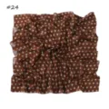 Detail view of a retro brown polka dot chiffon square scarf, lightweight fabric close-up. - Dinosaur Silhouette