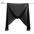 Detailed view of the lightweight black chiffon scarf hanging on a rod, soft texture. - Black (#1)