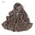 Detailed close-up of the soft pleated brown long scarf texture and fringe craftsmanship. - Style #10