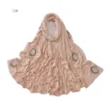 Detail shot of the sparkling rhinestone swirl embellishment on the light beige cotton scarf. - 12#
