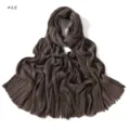 Detailed view of dark brown crinkled cotton linen long scarf featuring stylish fringe edges. - Style 15