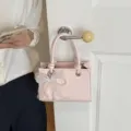 Chic pink woven small handbag for women, trendy messenger bag with cute bow and pearl pendant. - Pendant Included / Pink