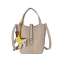 Chic leather bucket bag with top handle, shoulder strap, padlock, and cute winged horse charm. - Milk Tea
