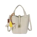 Stylish beige leather bucket bag variant with top handles and cute winged horse charm. - White