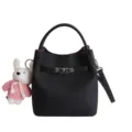 Chic black litchi pattern bucket bag with top handle, crossbody strap and cute rabbit pendant. - Black With Pendant