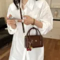 Stylish brown crocodile pattern handbag with cute cherry charm and premium golden hardware. - With Pendant / Brown