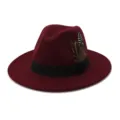 Close-up view of the wine red wool fedora hat featuring a black band and feather accent. - 58cm / Burgundy