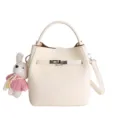 Stylish beige bucket bag with cute rabbit charm, top handle and crossbody strap. - Beige With Charm