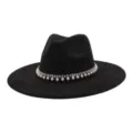 Close-up detail of black wide-brim fedora hat featuring sparkling rhinestone and pearl chain trim. - 58cm / Black