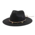 Black straw hat detail featuring gold chain, pearls, and coin pendants for summer beach style. - Black
