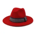 Close up view of the stylish woolen fedora hat showcasing its fine red texture and ethnic ribbon. - Red