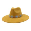 Close-up detail of yellow faux suede fedora hat featuring boho silver concho turquoise band. - 58cm / Turmeric