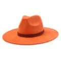 Details of the orange wide brim fedora hat featuring a tribal patterned brown leather band. - 58cm / Orange