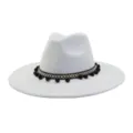 Detailed view of light grey suede fedora hat featuring bohemian woven pom pom band and flat brim. - Light Gray