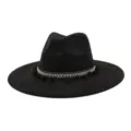 Close-up detail of the black fedora hat showing ethnic woven band and cute pom-poms. - Black