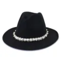 Close-up detail of elegant black wool fedora hat featuring exquisite pearl and beaded trim band. - Black