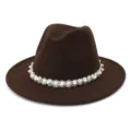 Close-up detail of the elegant brown fedora hat featuring a delicate pearl beaded band. - Coffee