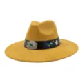Detailed shot of the yellow suede fedora hat with black leather band and floral embroidery. - 58cm / Turmeric