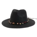Detailed close-up of the black straw sun hat featuring a decorative beaded cord band style. - Black