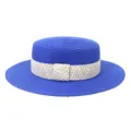 Detailed view of a stylish blue flat-top straw hat with a woven patterned band for summer outdoor travel. - 58cm / Sapphire Blue