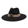 Detailed view of black wide-brim fedora hat with embroidered band and gemstone buckle. - 58cm / Black