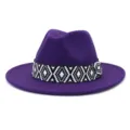 Detail view of a purple felt fedora hat featuring a stylish black and white woven geometric band. - 58cm / Purple