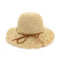 Detailed view of the women summer crochet straw hat with wide brim and cute bow tie ribbon. - Beige