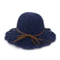 Close-up detail of navy blue crochet straw hat featuring brown suede bow decoration. - Navy Blue